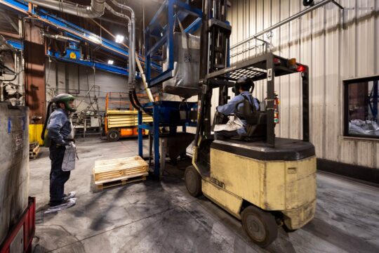 Hammond Employees moving materials with a forklift in the Expander plant.