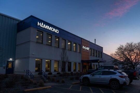 Hammond building with lighted signs at sunset