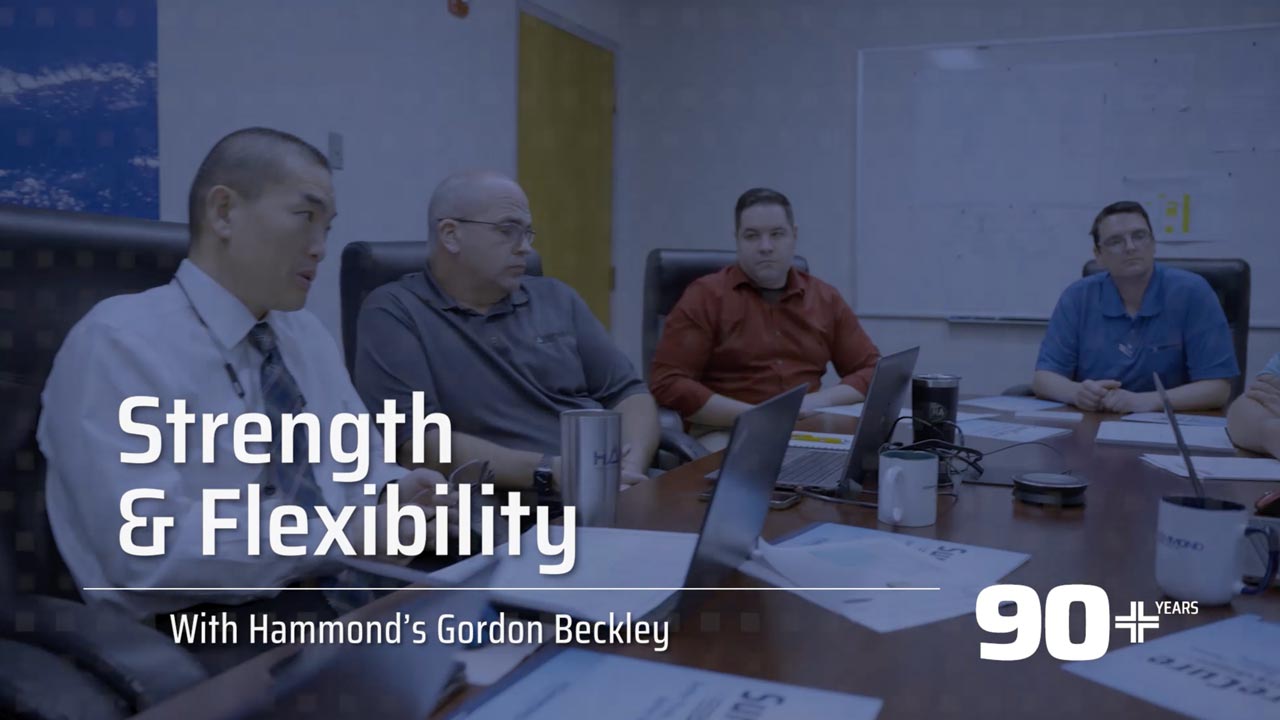 People in meeting room around a table with text "Strength and Flexibility"