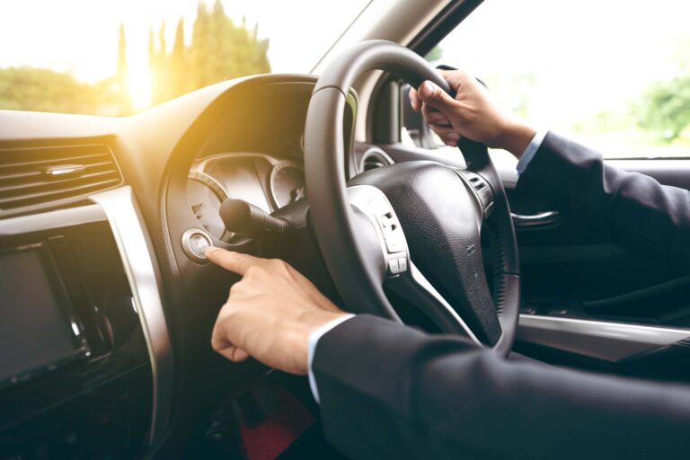 close view of hands on a car steering wheel